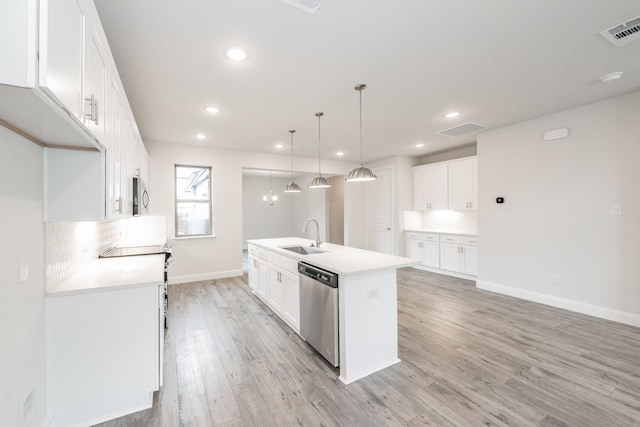 9709 Thorncrown Ln, Fort Worth, TX 76179 - kitchen featuring stainless steel appliances, an island with sink, light wood-type flooring, white cabinetry, and baseboards