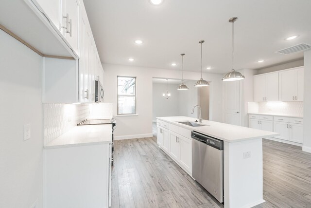 9709 Thorncrown Ln, Fort Worth, TX 76179 - kitchen featuring appliances with stainless steel finishes, a sink, decorative backsplash, light wood-style floors, and recessed lighting