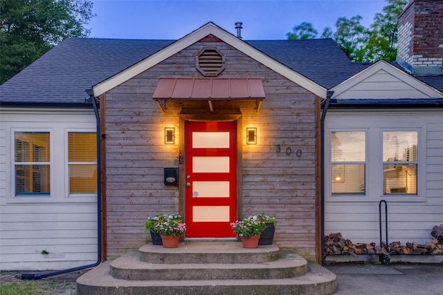 1300 Mountain Lake Rd, Dallas, TX 75224 - exterior entry at dusk featuring roof with shingles