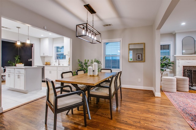 1300 Mountain Lake Rd, Dallas, TX 75224 - dining room featuring light wood finished floors, baseboards, a fireplace, and recessed lighting