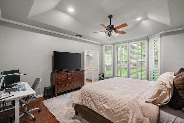 1304 Brook Arbor Dr, Mansfield, TX 76063 - bedroom with dark wood-type flooring, a tray ceiling, an office area, ensuite bathroom, and ceiling fan