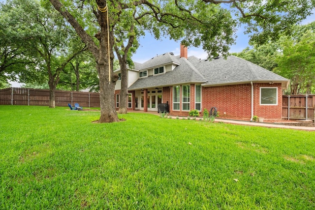 1304 Brook Arbor Dr, Mansfield, TX 76063 - back of property featuring a shingled roof, brick siding, and a chimney