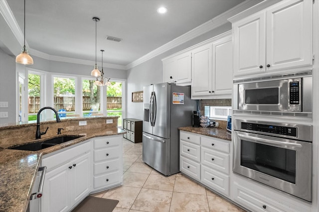 1304 Brook Arbor Dr, Mansfield, TX 76063 - kitchen with stainless steel appliances, a sink, ornamental molding, white cabinets, and dark stone counters