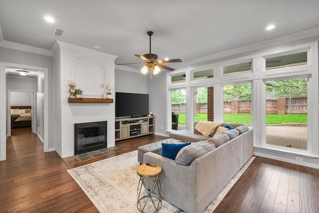 1304 Brook Arbor Dr, Mansfield, TX 76063 - living room with ornamental molding, a ceiling fan, a fireplace, dark wood-style floors, and baseboards