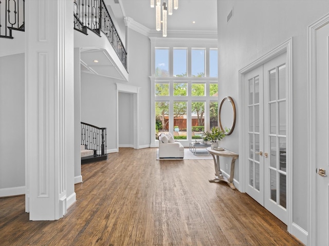 5916 Orchard Park Dr, Frisco, TX 75034 - entryway featuring stairway, a towering ceiling, ornamental molding, french doors, and wood finished floors
