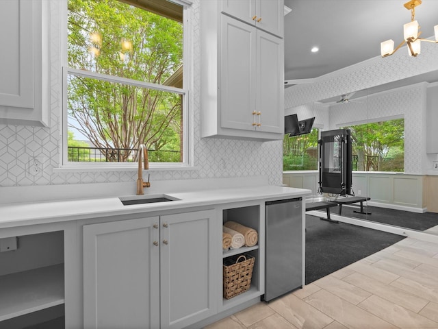 5916 Orchard Park Dr, Frisco, TX 75034 - kitchen with fridge, a sink, decorative backsplash, light countertops, and plenty of natural light