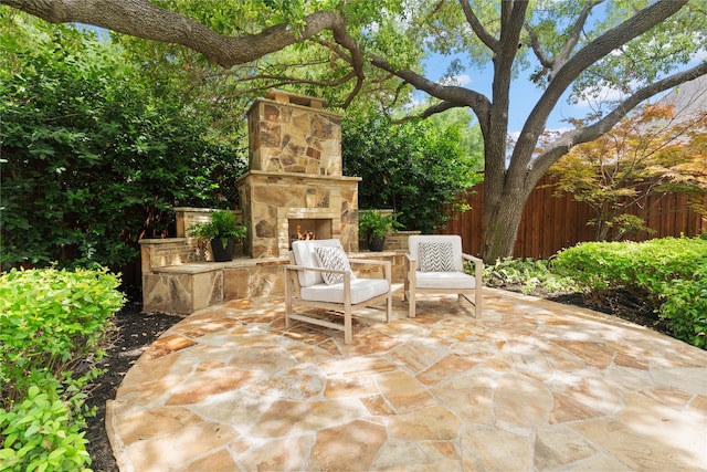 5916 Orchard Park Dr, Frisco, TX 75034 - view of patio / terrace with an outdoor stone fireplace and fence