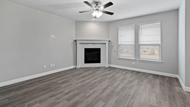 1913 Brindle St, Northlake, TX 76247 - unfurnished living room with a ceiling fan, wood finished floors, baseboards, and a tiled fireplace