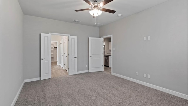 1913 Brindle St, Northlake, TX 76247 - unfurnished bedroom featuring light colored carpet, a walk in closet, baseboards, and a ceiling fan