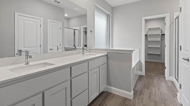 1913 Brindle St, Northlake, TX 76247 - full bath featuring a shower stall, wood finished floors, double vanity, baseboards, and a walk in closet