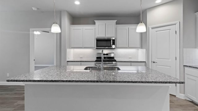 1913 Brindle St, Northlake, TX 76247 - kitchen with appliances with stainless steel finishes, a sink, recessed lighting, backsplash, and dark stone countertops