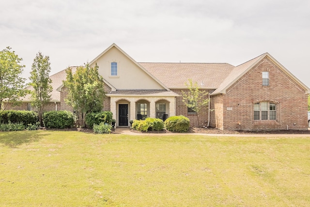 1132 Mount Ln, Rhome, TX 76078 - view of front facade featuring a front lawn, brick siding, and stucco siding