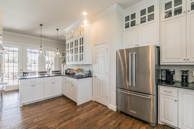 1132 Mount Ln, Rhome, TX 76078 - kitchen featuring high end refrigerator, a peninsula, dark countertops, dark wood-style flooring, and tasteful backsplash