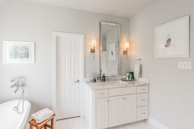 1132 Mount Ln, Rhome, TX 76078 - full bathroom with marble look tiles, a freestanding tub, vanity, and baseboards