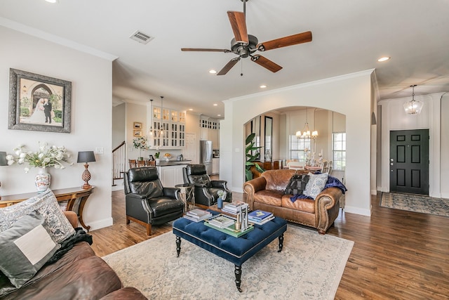 1132 Mount Ln, Rhome, TX 76078 - living area featuring arched walkways, a chandelier, crown molding, ceiling fan, and wood finished floors