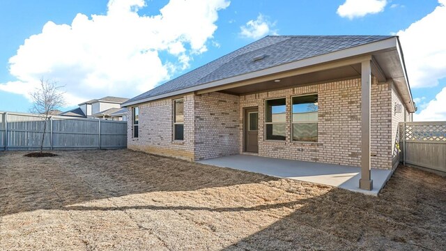 1900 Stetson St, Northlake, TX 76247 - rear view of property featuring brick siding, a fenced backyard, a patio, and roof with shingles