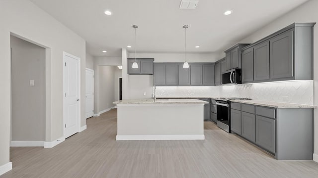 1900 Stetson St, Northlake, TX 76247 - kitchen featuring stainless steel appliances, gray cabinets, decorative backsplash, and recessed lighting