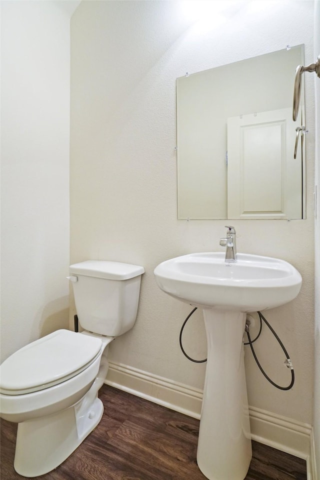 7132 Huckleberry Dr, Mckinney, TX 75070 - bathroom featuring wood finished floors, toilet, and baseboards