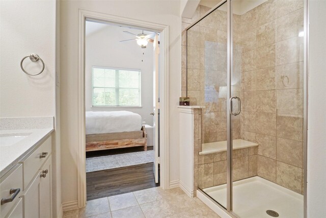 7132 Huckleberry Dr, Mckinney, TX 75070 - ensuite bathroom with a shower stall, ceiling fan, vanity, tile patterned flooring, and baseboards
