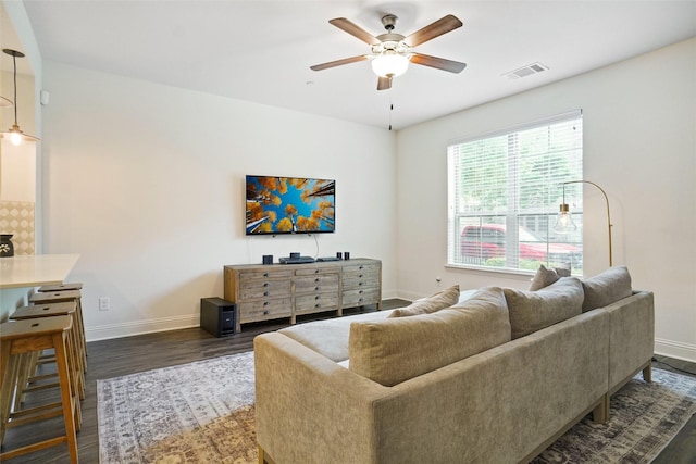 7132 Huckleberry Dr, Mckinney, TX 75070 - living area featuring baseboards, dark wood-style flooring, and a ceiling fan