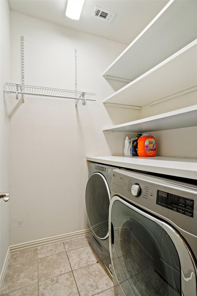 7132 Huckleberry Dr, Mckinney, TX 75070 - clothes washing area with washer and clothes dryer, baseboards, and light tile patterned floors