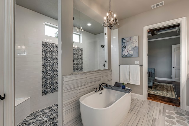 6470 Eyrie Bnd, Waxahachie, TX 75167 - full bathroom featuring walk in shower, a freestanding tub, a chandelier, and baseboards