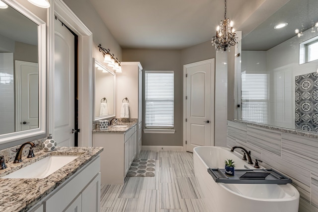 6470 Eyrie Bnd, Waxahachie, TX 75167 - bathroom with a freestanding bath, two vanities, and a chandelier