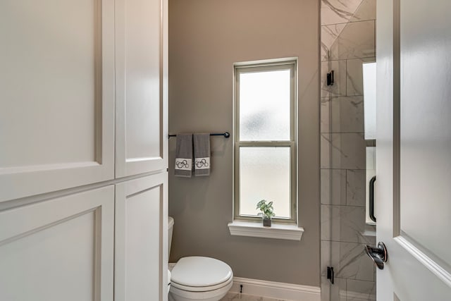 6470 Eyrie Bnd, Waxahachie, TX 75167 - bathroom with a shower stall, toilet, healthy amount of natural light, and baseboards