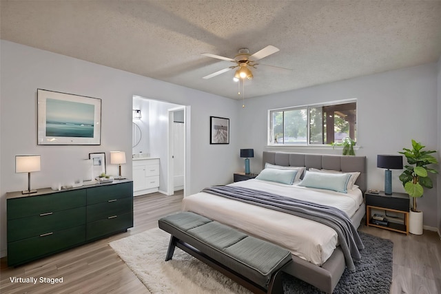 7357 Channel View Dr, Fort Worth, TX 76133 - bedroom featuring light wood-type flooring, a textured ceiling, baseboards, ensuite bathroom, and a ceiling fan