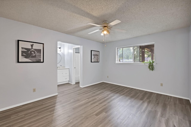 7357 Channel View Dr, Fort Worth, TX 76133 - empty room with wood finished floors, a ceiling fan, a textured ceiling, and baseboards