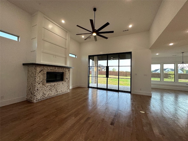 145 Chisolm Trl, Pottsboro, TX 75076 - unfurnished living room featuring ceiling fan, baseboards, dark wood-style floors, a fireplace, and recessed lighting