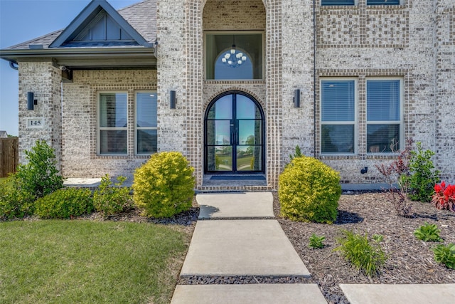 145 Chisolm Trl, Pottsboro, TX 75076 - doorway to property featuring brick siding and board and batten siding