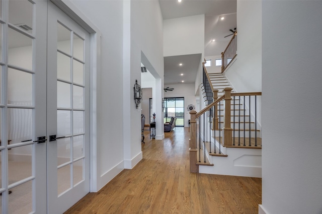 145 Chisolm Trl, Pottsboro, TX 75076 - foyer entrance with a ceiling fan, french doors, wood finished floors, a towering ceiling, and stairway