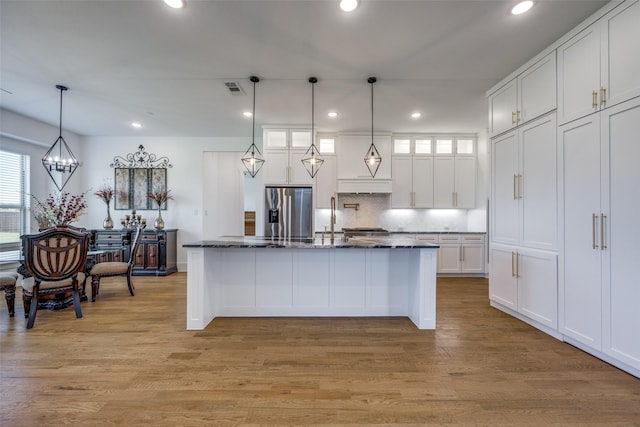145 Chisolm Trl, Pottsboro, TX 75076 - kitchen featuring stainless steel fridge with ice dispenser, white cabinets, decorative backsplash, custom range hood, and light wood finished floors
