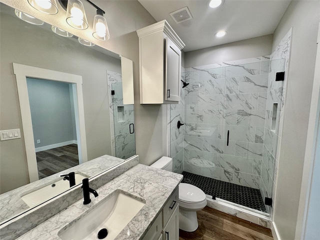 913 Carter, Sulphur Springs, TX 75482 - full bathroom with toilet, wood finished floors, a stall shower, vanity, and recessed lighting