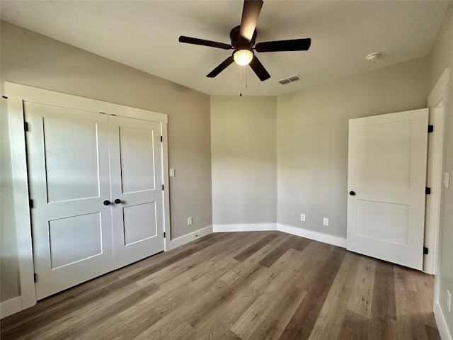 913 Carter, Sulphur Springs, TX 75482 - unfurnished bedroom with wood finished floors, baseboards, a closet, and a ceiling fan