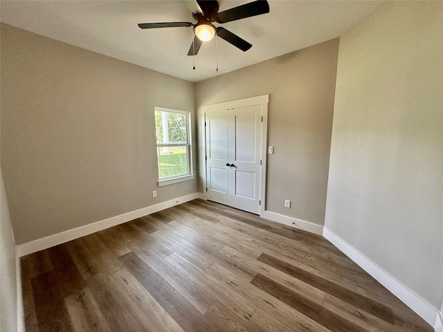913 Carter, Sulphur Springs, TX 75482 - unfurnished bedroom featuring wood finished floors, baseboards, and a ceiling fan