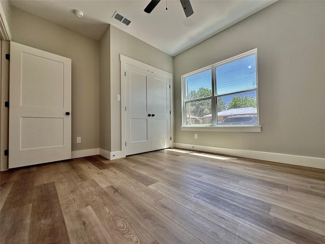 913 Carter, Sulphur Springs, TX 75482 - unfurnished bedroom featuring wood finished floors, baseboards, and a ceiling fan