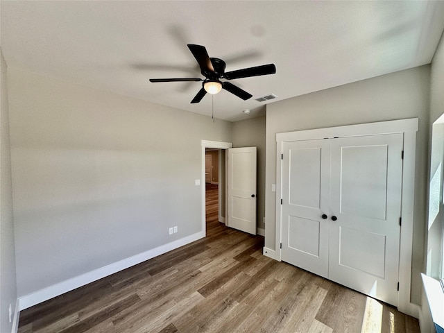 913 Carter, Sulphur Springs, TX 75482 - unfurnished bedroom with baseboards, wood finished floors, a closet, and a ceiling fan