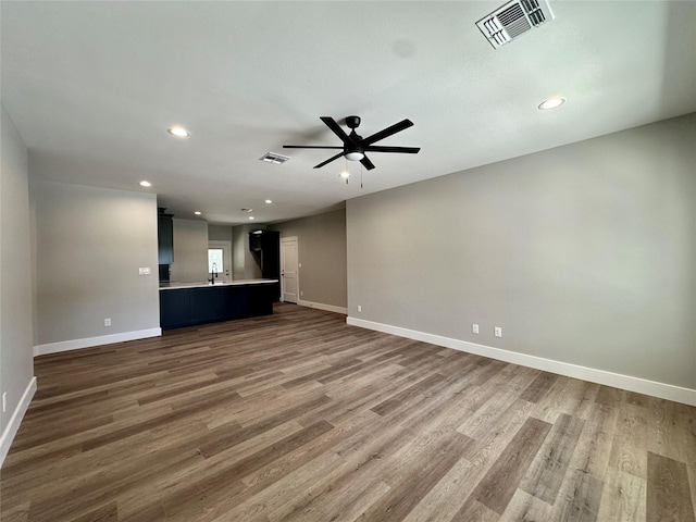 913 Carter, Sulphur Springs, TX 75482 - unfurnished living room with baseboards, a ceiling fan, wood finished floors, and recessed lighting
