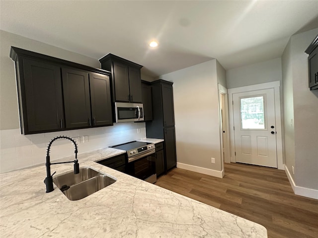 913 Carter, Sulphur Springs, TX 75482 - kitchen with appliances with stainless steel finishes, a sink, baseboards, wood finished floors, and recessed lighting