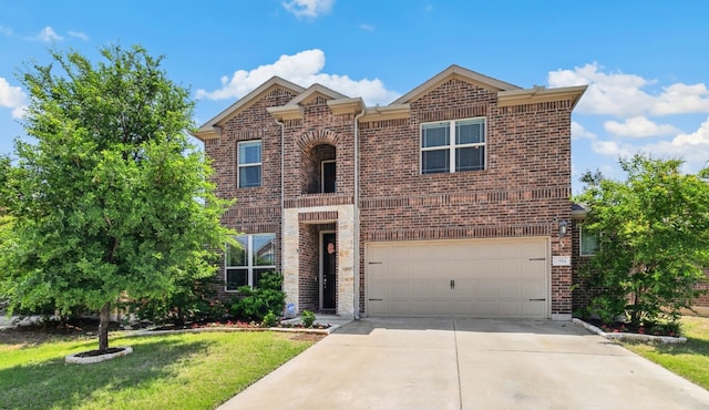 1904 Tomahawk Trl, Aubrey, TX 76227 - traditional home featuring brick siding, a garage, driveway, and a front yard
