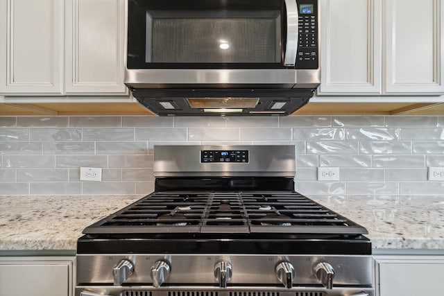 1904 Tomahawk Trl, Aubrey, TX 76227 - kitchen view of stainless steel appliances, decorative backsplash, white cabinetry, and light stone countertops