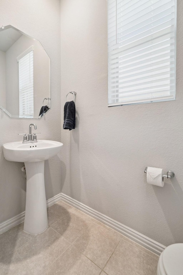 1904 Tomahawk Trl, Aubrey, TX 76227 - half bathroom featuring baseboards, tile patterned flooring, toilet, and a sink