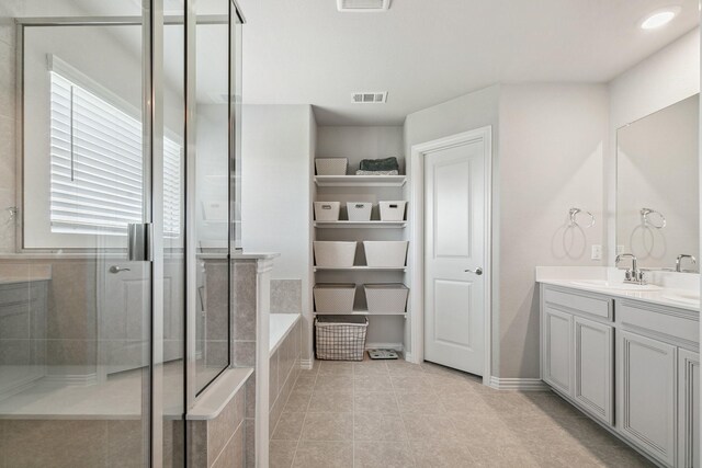 1904 Tomahawk Trl, Aubrey, TX 76227 - bathroom featuring a tile shower, a bath, vanity, tile patterned flooring, and baseboards