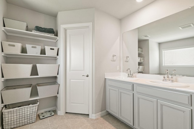 1904 Tomahawk Trl, Aubrey, TX 76227 - bathroom featuring baseboards, double vanity, and tile patterned flooring