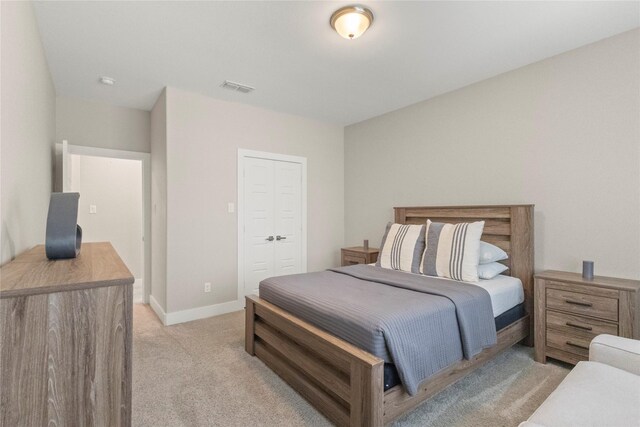 2027 Shaw St, Dallas, TX 75212 - bedroom with light carpet, a closet, and baseboards