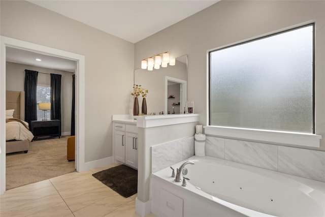 2027 Shaw St, Dallas, TX 75212 - full bathroom featuring vanity, a whirlpool tub, connected bathroom, marble finish floors, and baseboards