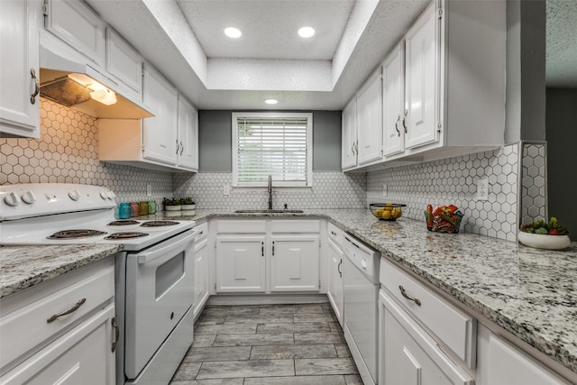 2929 Forest Park Dr, Garland, TX 75040 - kitchen featuring white appliances, a sink, white cabinets, under cabinet range hood, and recessed lighting