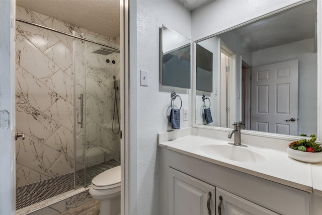 2929 Forest Park Dr, Garland, TX 75040 - full bathroom with a marble finish shower, toilet, vanity, and a textured wall